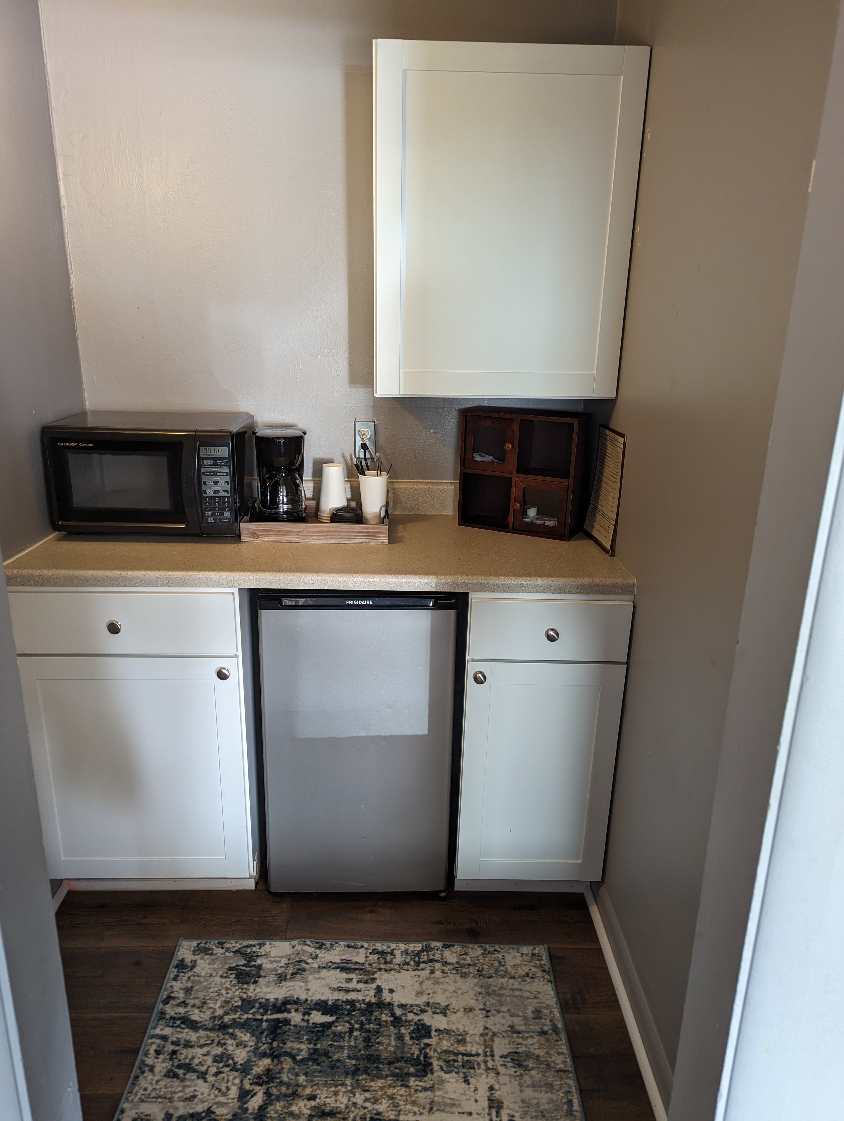 Hotel room amenities including coffee maker and refrigerator